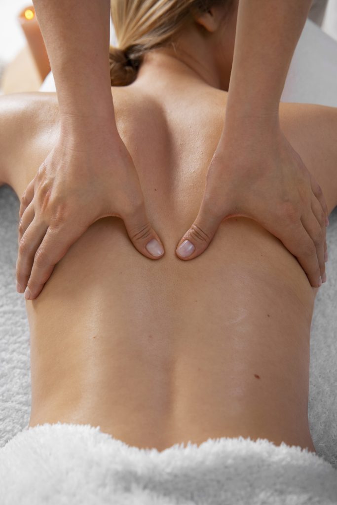 woman getting back massage from masseur